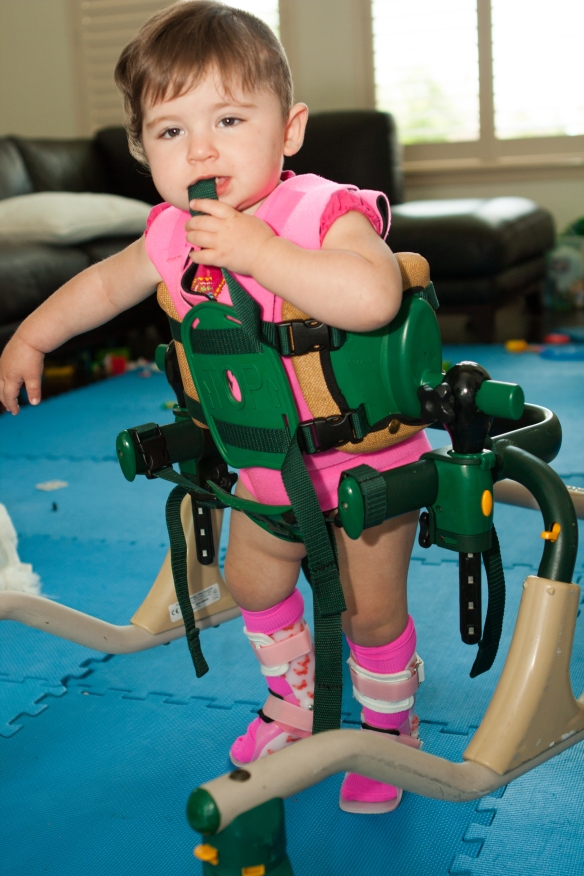 Savanna decked out with a compression vest, AFO's, and a medical walker.